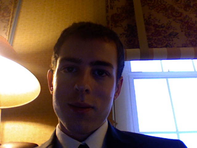 a man wearing a suit in a el room