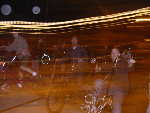 people riding bikes on the street at night