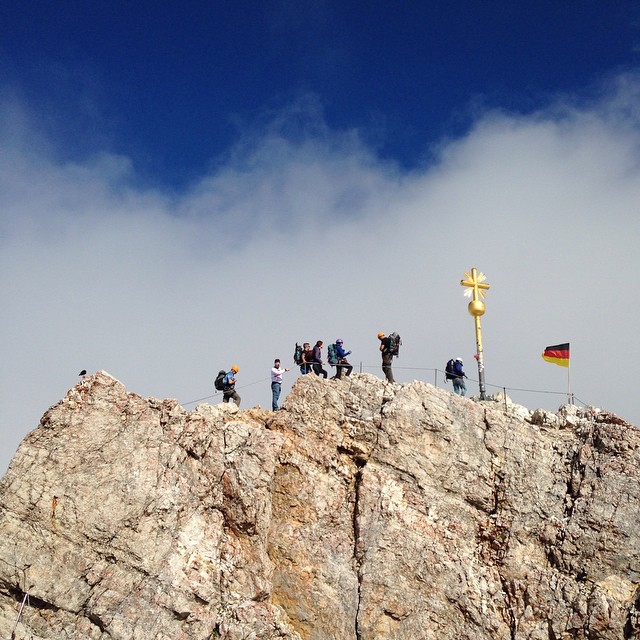 a group of people standing on top of a cliff