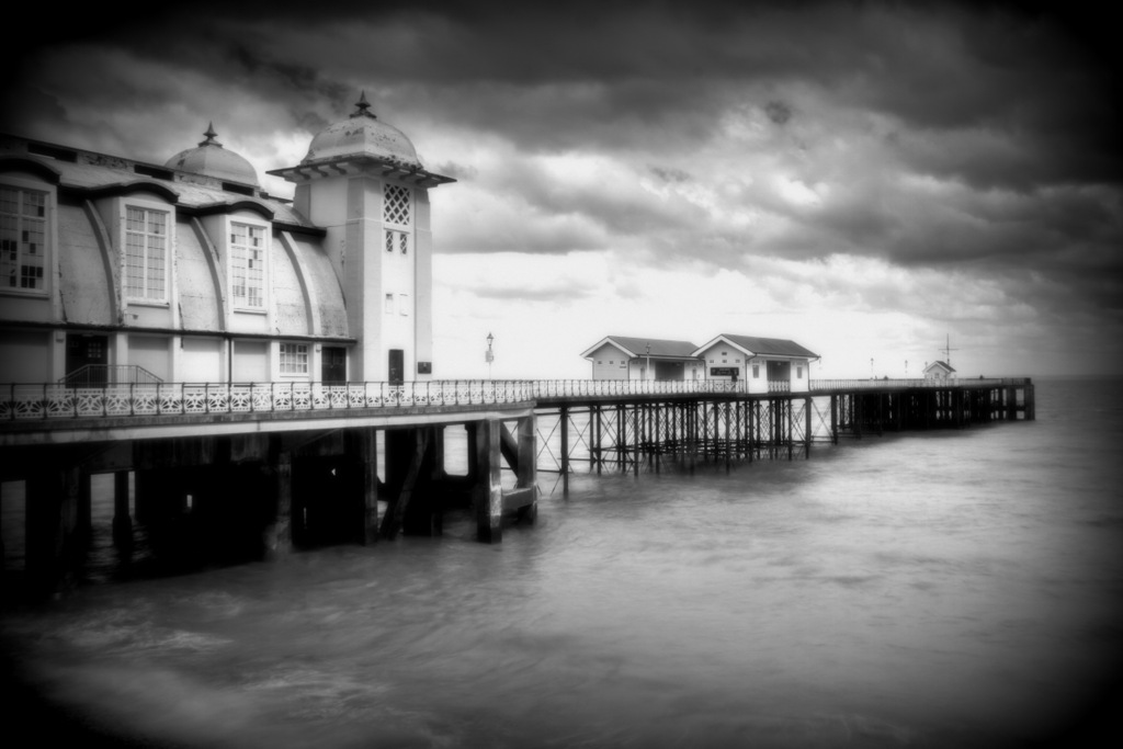 old pier in black and white on the beach