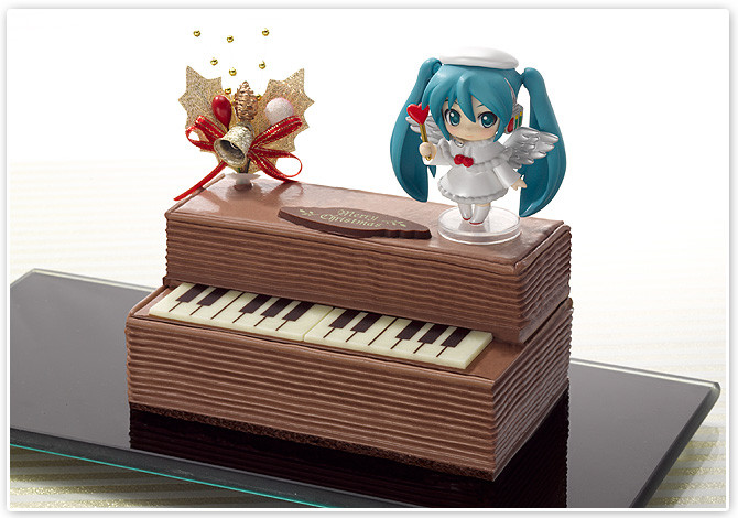 a music box with a vocal keyboard sitting next to a cartoon figure