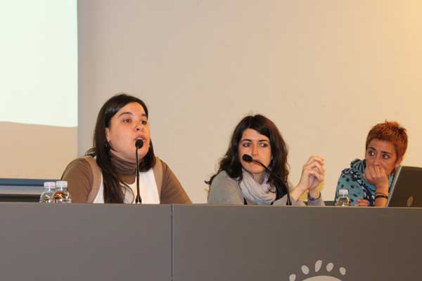 three people sitting at the front of a panel