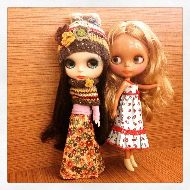 two doll posed next to each other in dresses