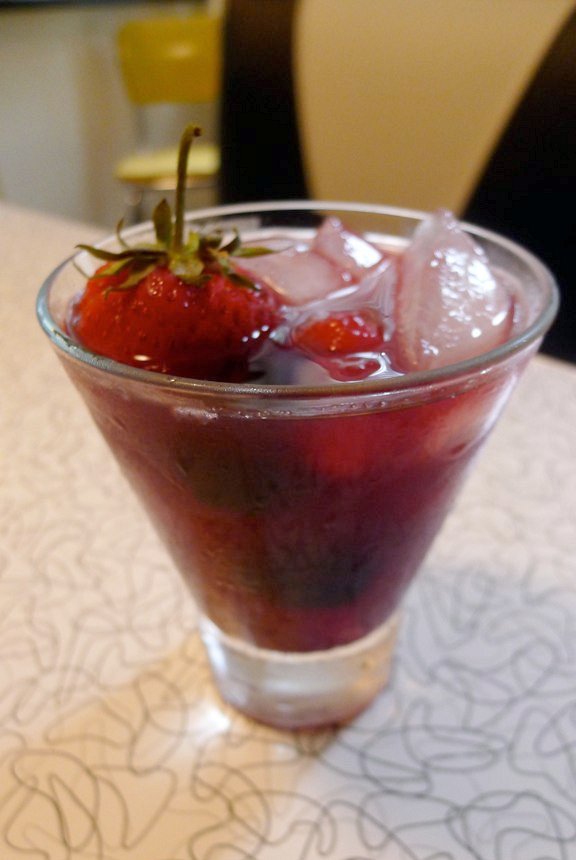 a small dessert in a clear glass sits on a table