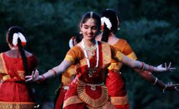 some indian girls performing a dance in an outdoor event