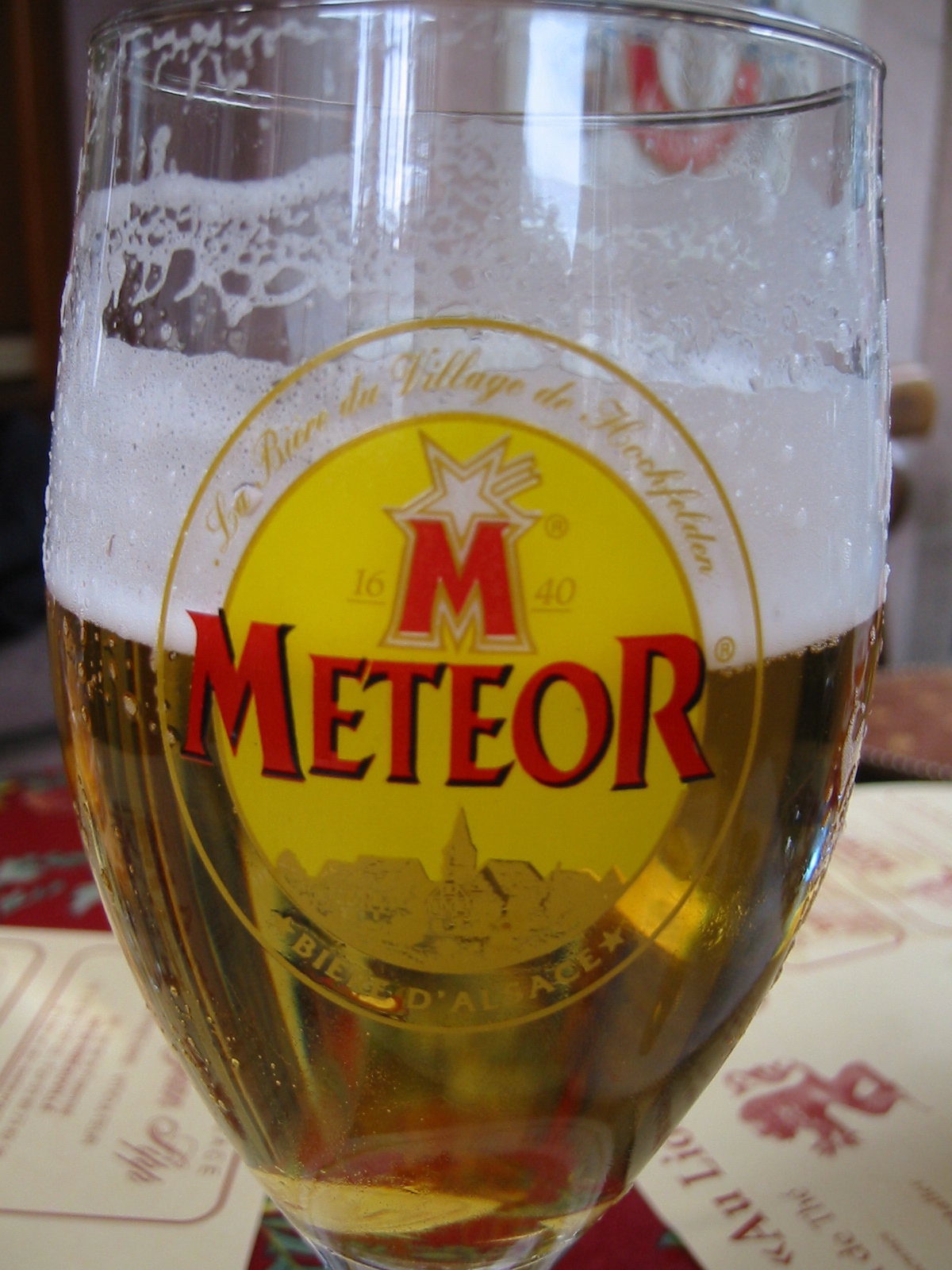there is a glass that says meteor sitting on the table
