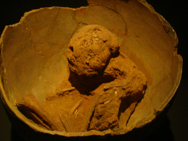 an old stone bowl with a large head