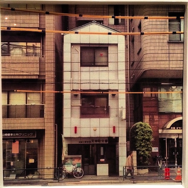 a building in the foreground with a person standing outside