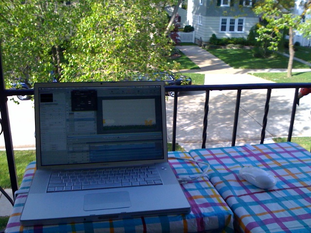 a laptop computer sitting on a plaid tablecloth