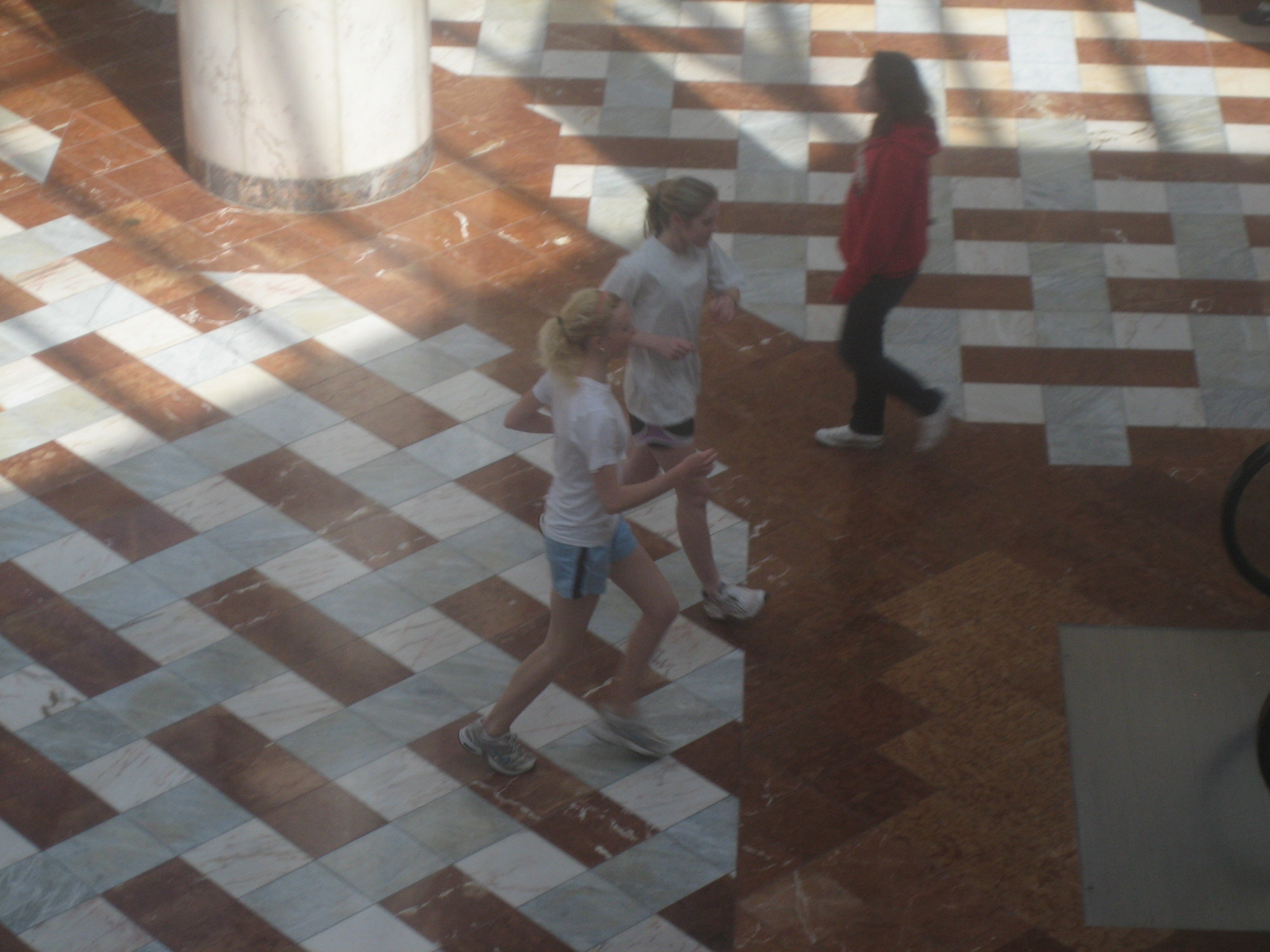 three girls in an indoor area playing on the ground