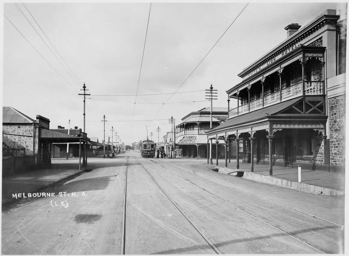 this old pograph shows an intersection with many buildings