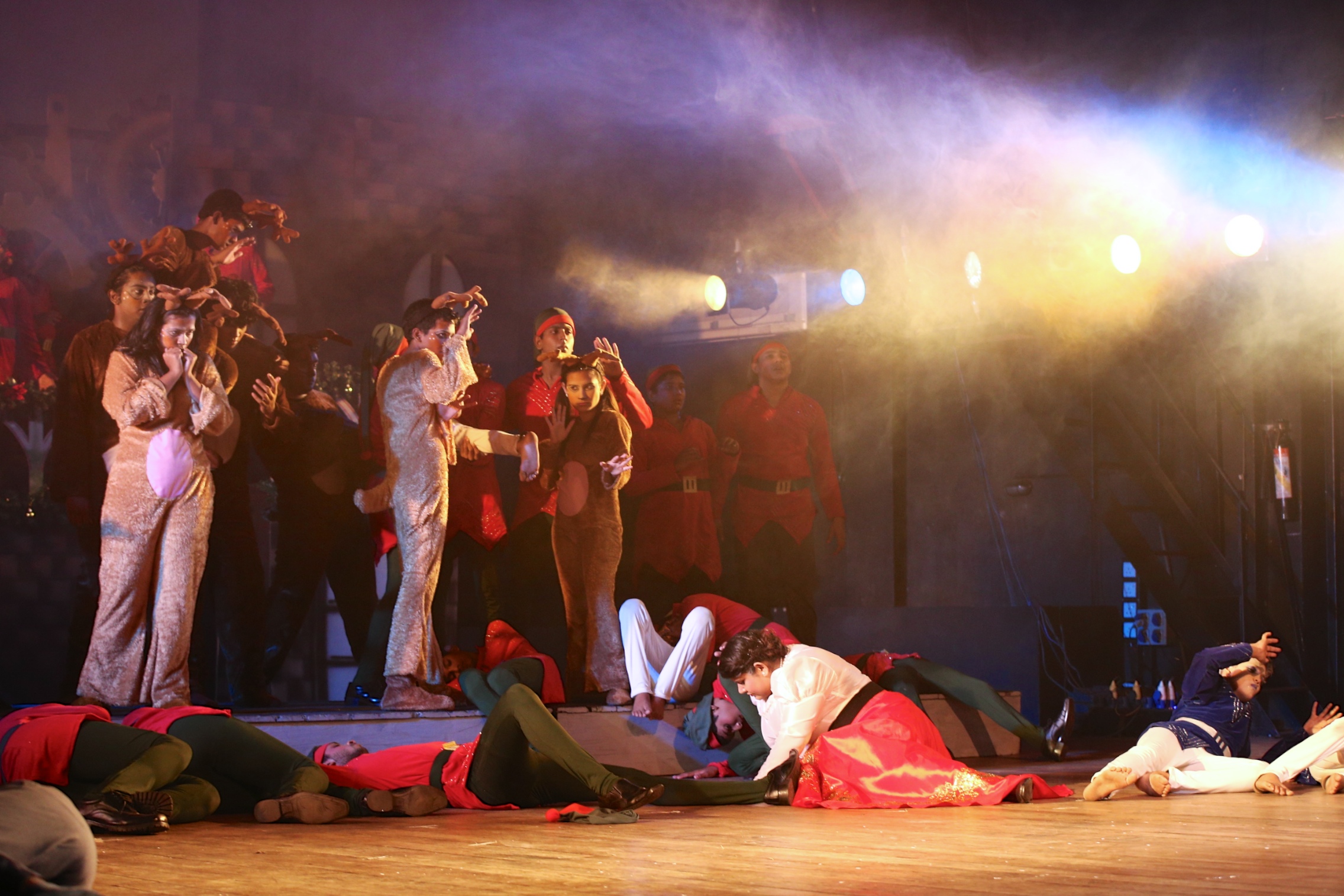 a group of people laying on the ground with their faces close together