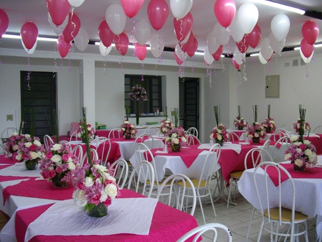 a banquet hall decorated for a pink and white wedding