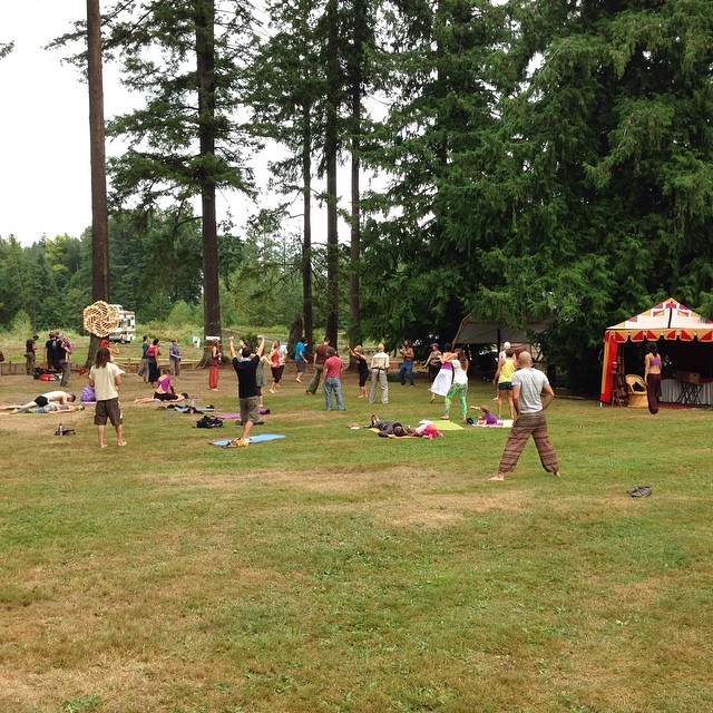 people gather in a field for an outside concert