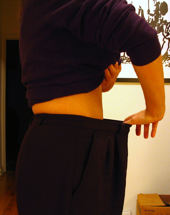 the back view of a man wearing a purple sweater
