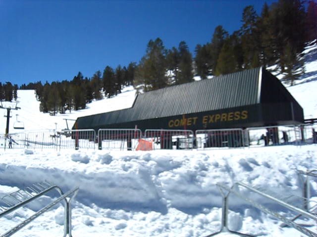a snow covered ski resort and ski lift