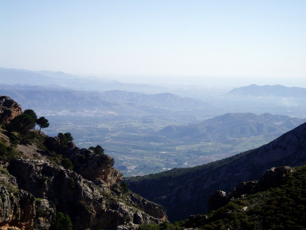 a view over mountains and valleys from the top of a hill