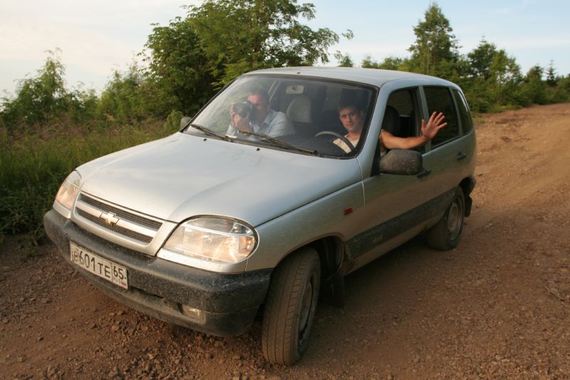 a man sitting in the passenger seat of a vehicle