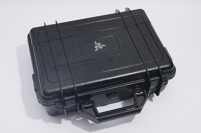 a box filled with black plastic cases on top of a white surface