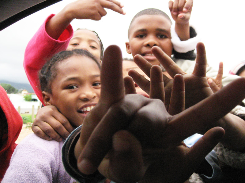 group of s reaching up their hands to the camera