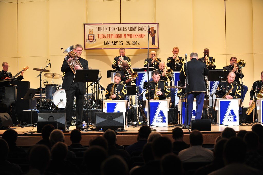 a band in uniforms playing on a stage