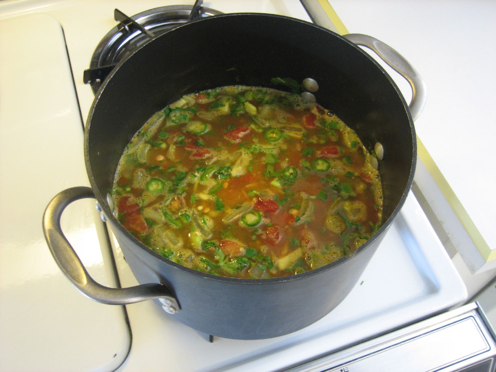 a pot full of soup is sitting on the stove