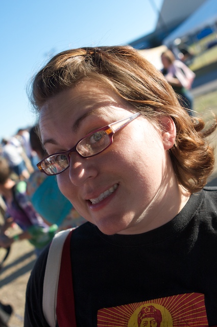a lady with glasses smiling at the camera