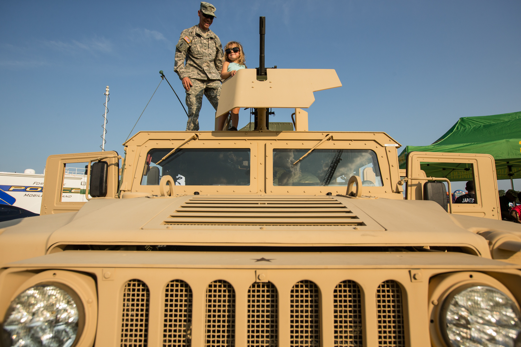 a man standing on the top of a vehicle