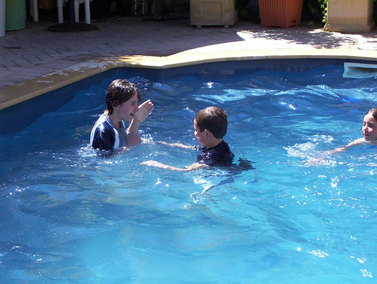a couple of s playing in a pool together