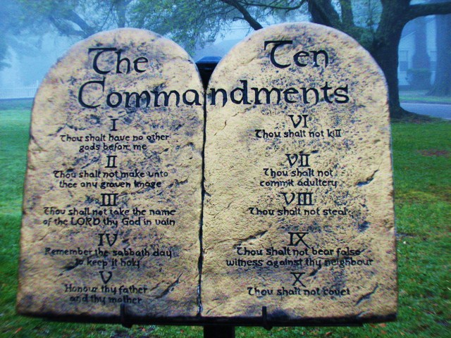 two stone tombstones that are near each other in the grass