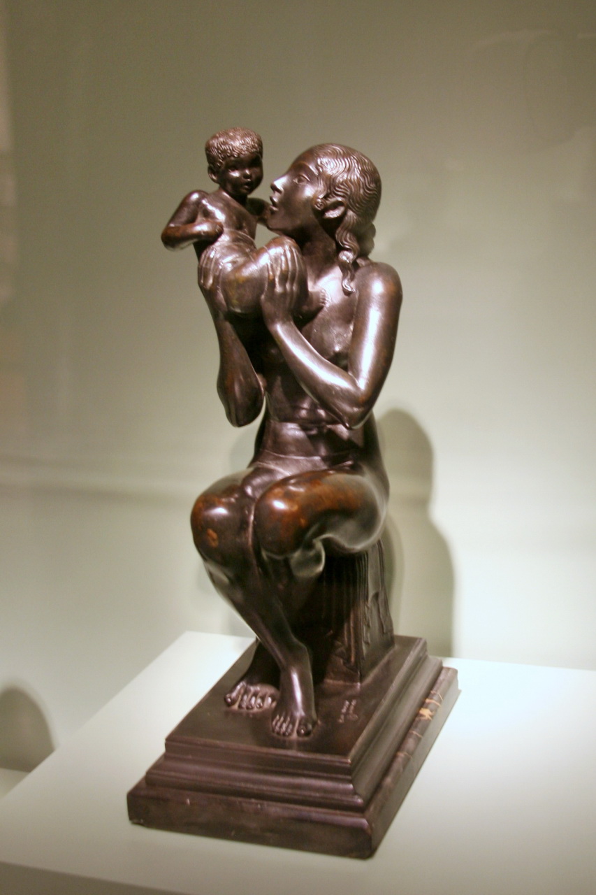 the bronze statue of an emcers hands holds a child