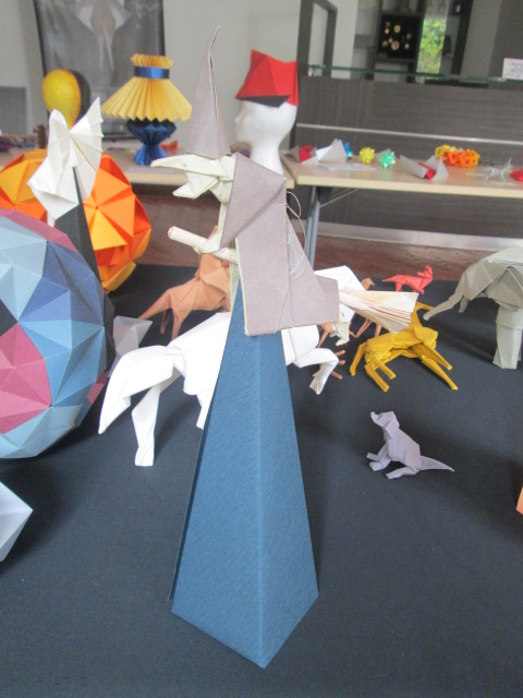 origami sculptures and other colorful paper animals on the table