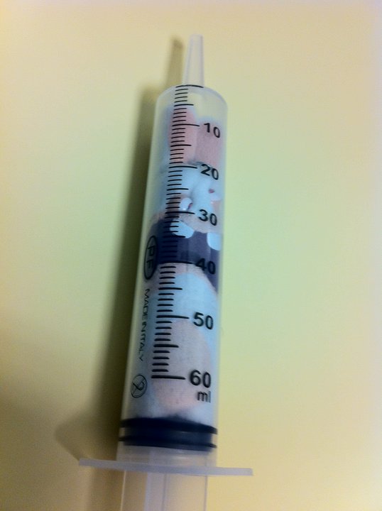 a thermometer placed on the top of a white wall