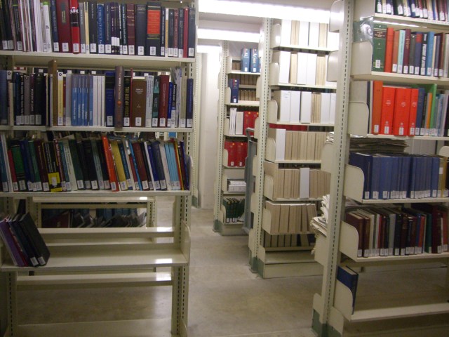 rows of books on shelves in an aisle