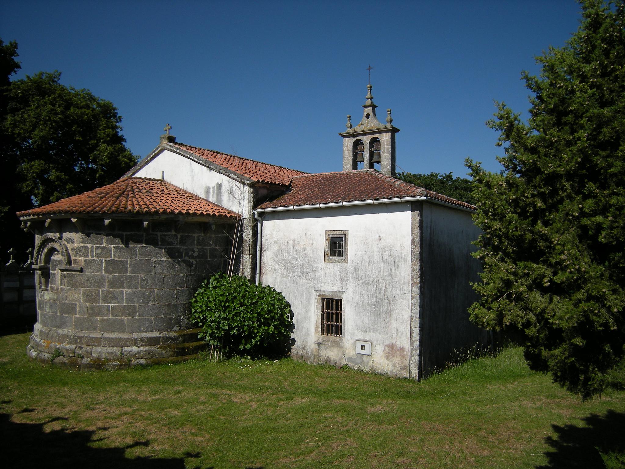 there is an old church building in the green grass