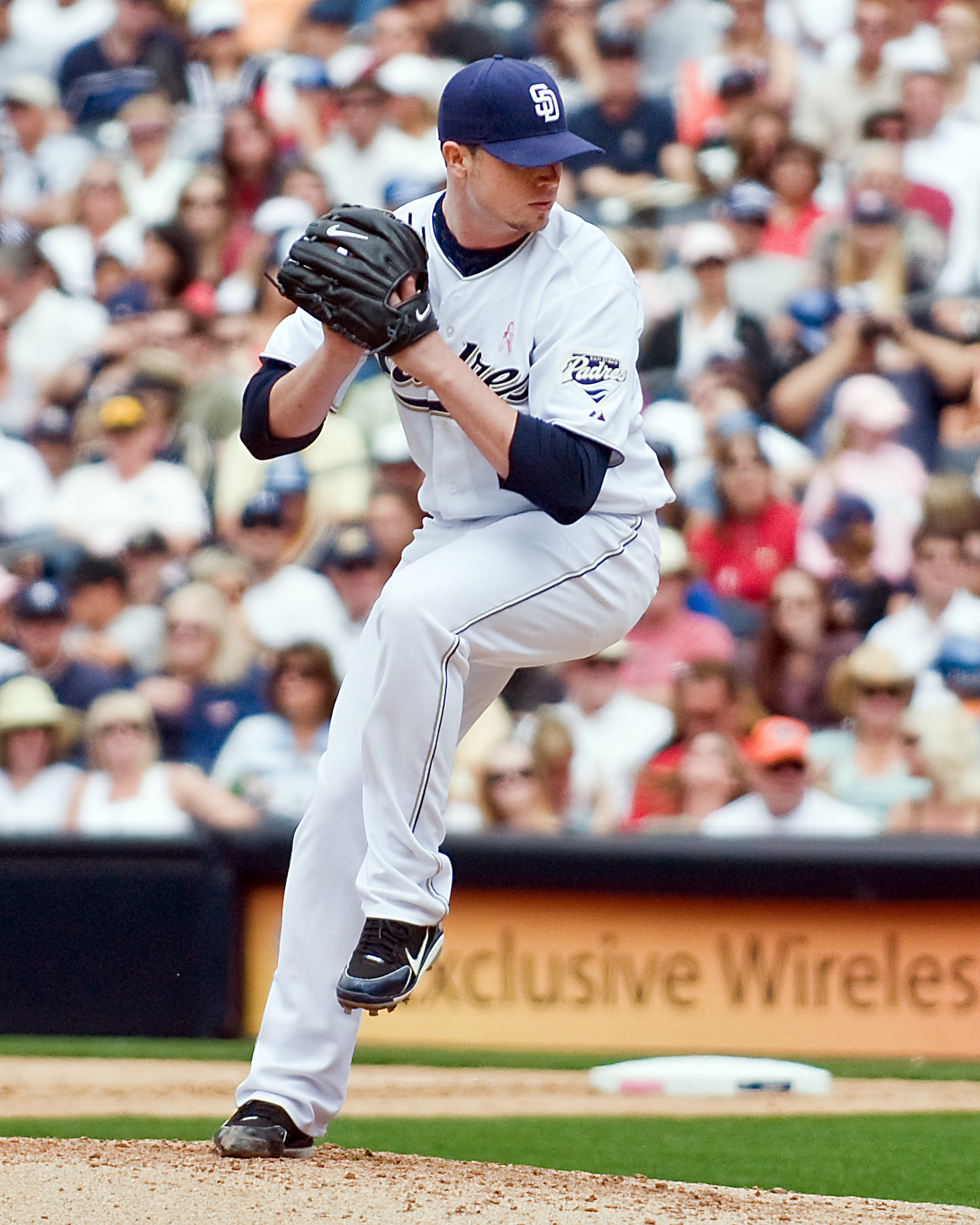 a man with his arm out and his hand up in the air holding a baseball