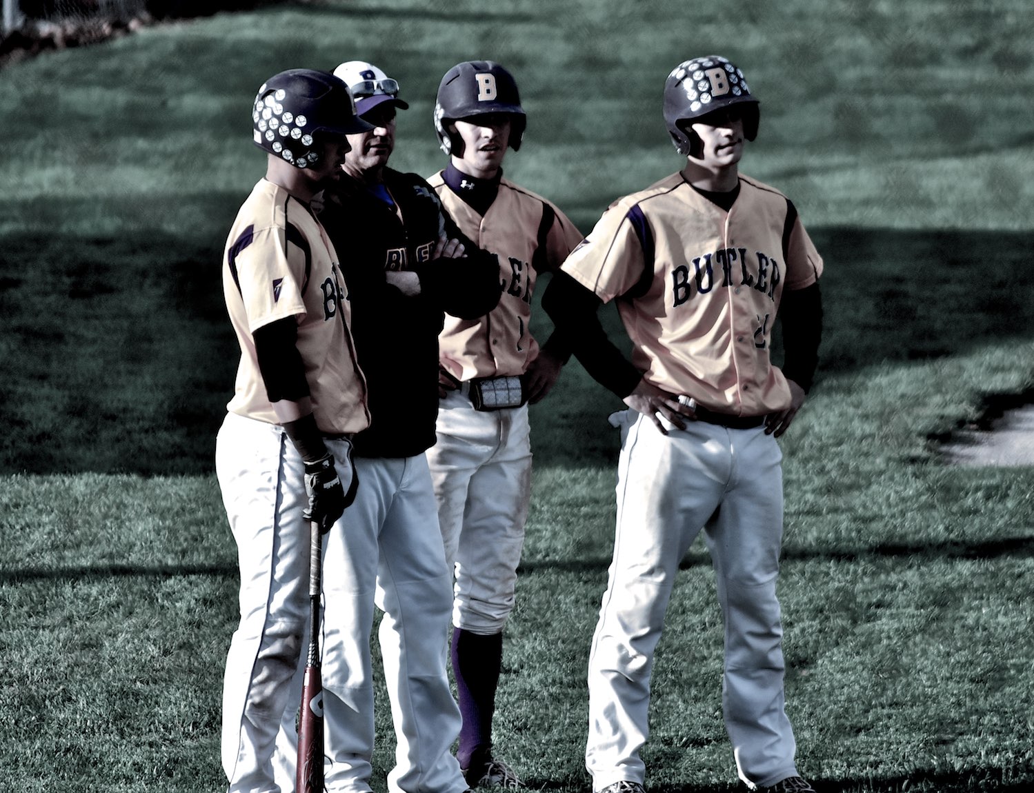 a couple of young baseball players standing on top of a field