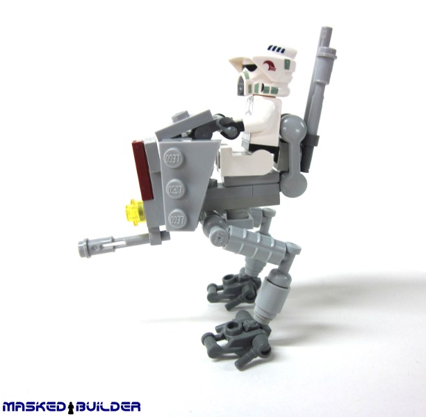 a toy robot is holding a rifle and a brick