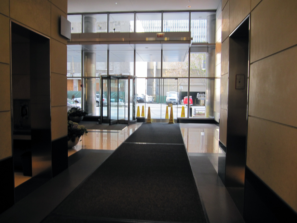 an empty hallway leads to a massive entrance to the lobby