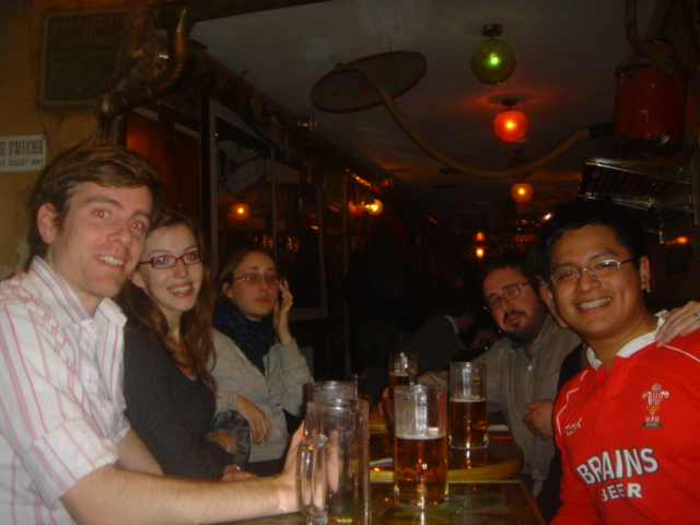 group of people sitting around beer glasses at table