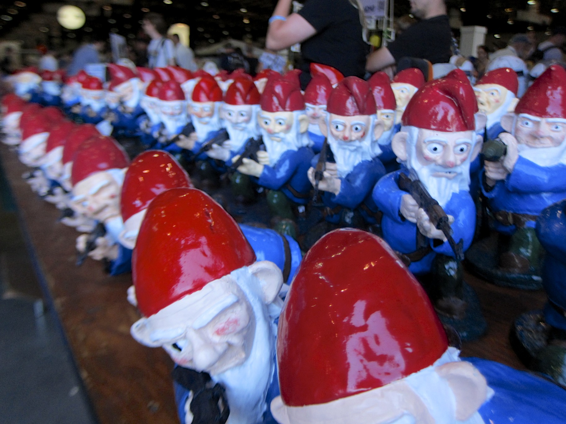 some toy gnomes laying down next to a man