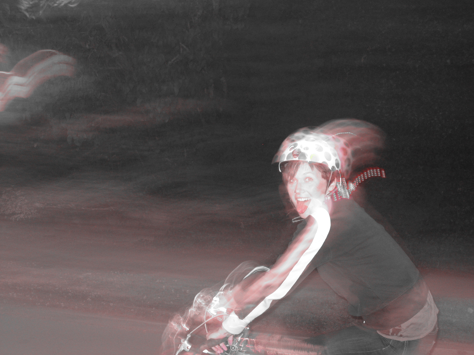 a blurry image of a young man in a helmet riding a skateboard