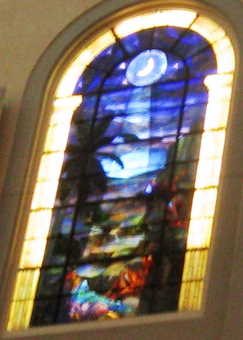 stained glass window with fish in blue sky