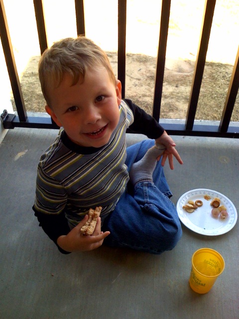 the  smiles while eating a snack on the patio