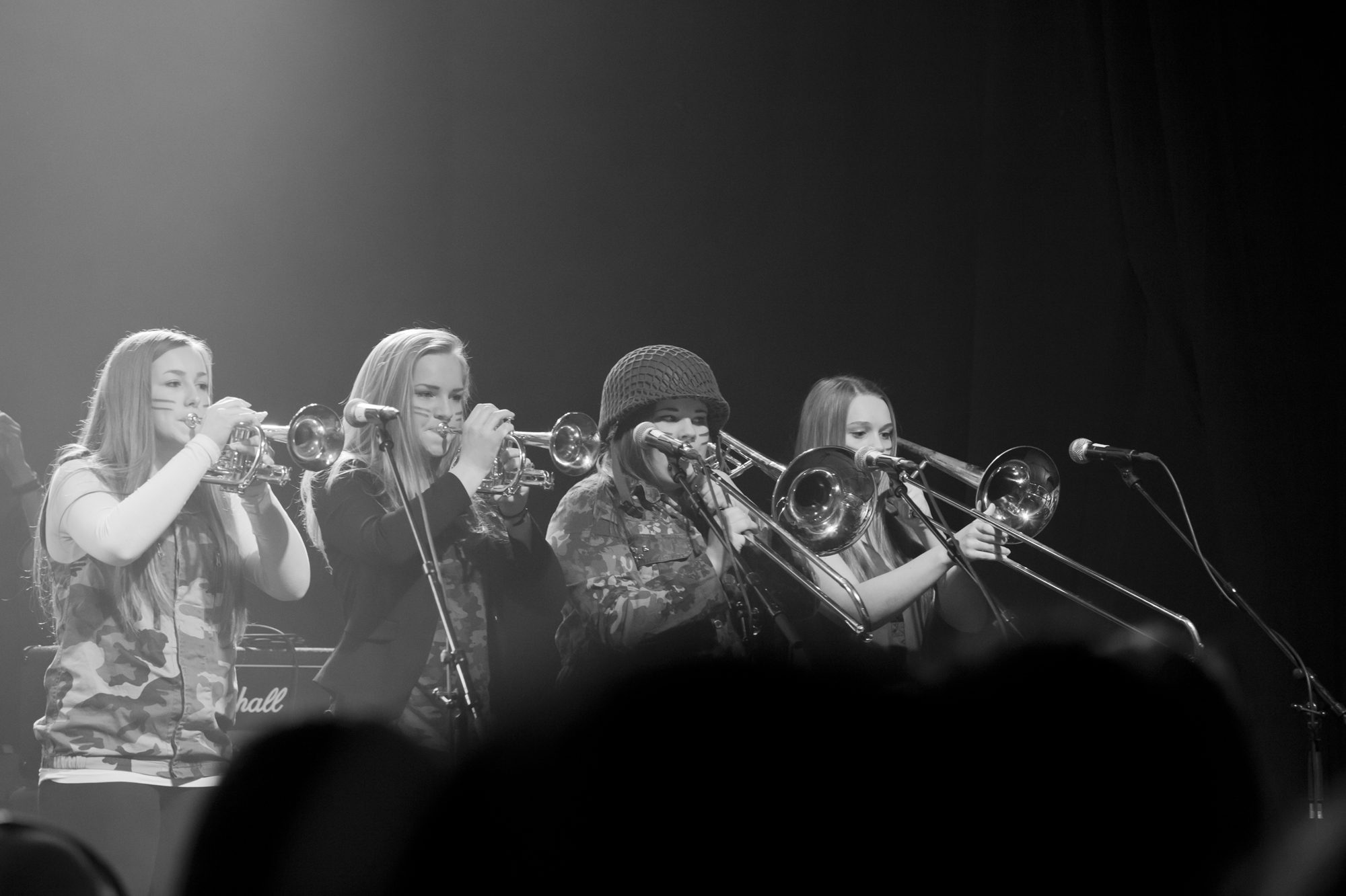 the trombone section of this band is holding their instruments