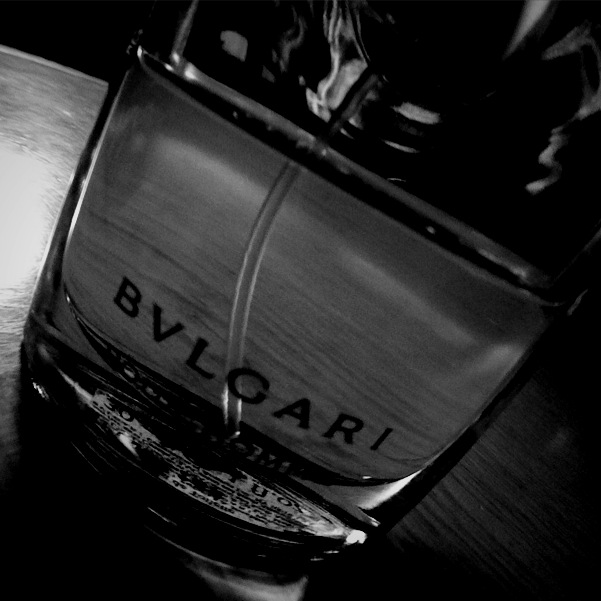 black and white pograph of a close up of a bottle of bvlgari