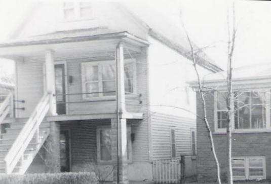an old black and white po of a tall house