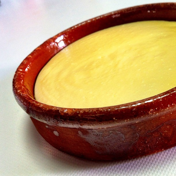 a yellow cake in a wood rimed bowl