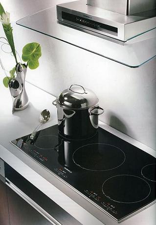 a stainless steel kitchen oven has a pot on the counter