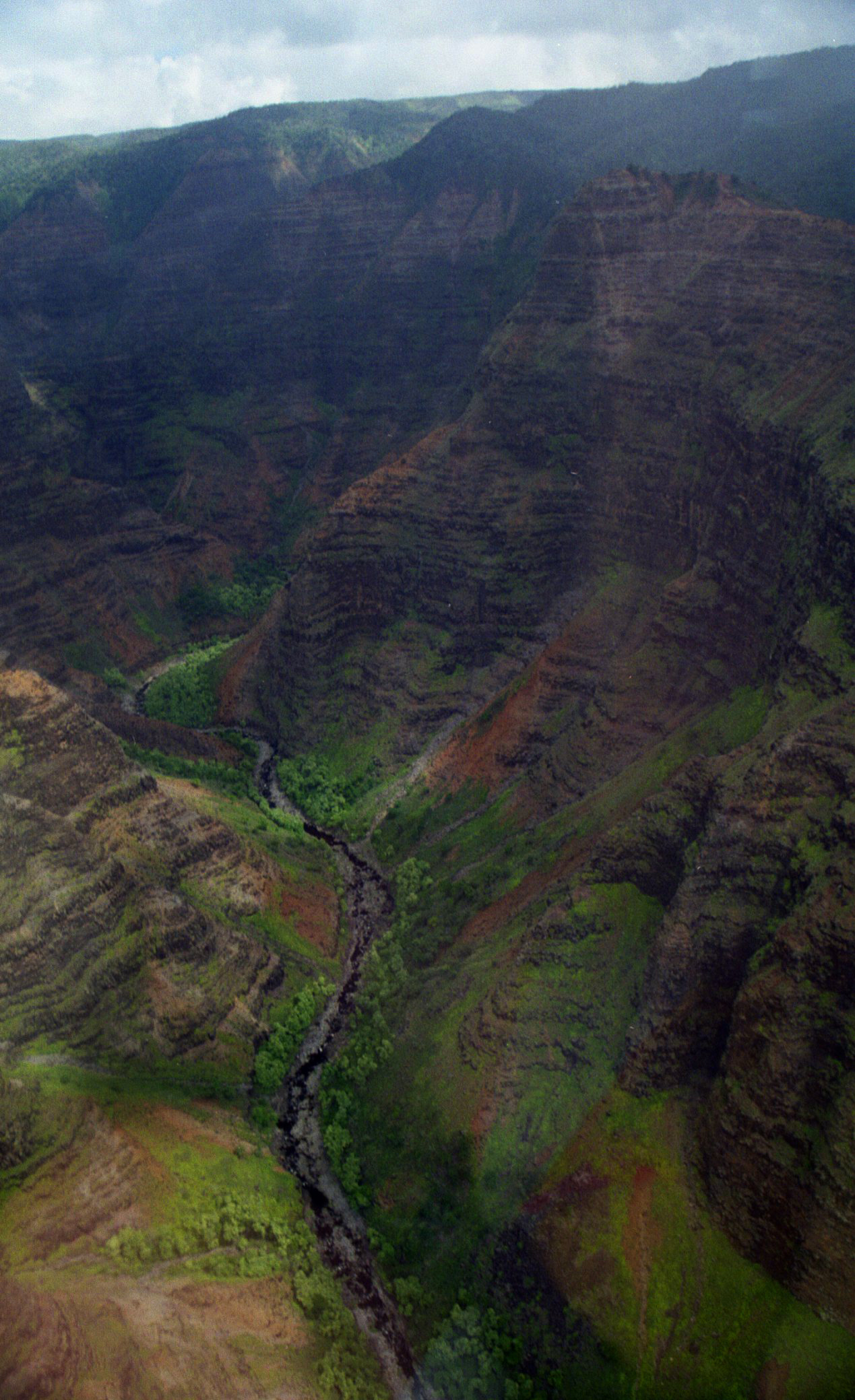 a po taken from a small airplane of a river in a hilly valley